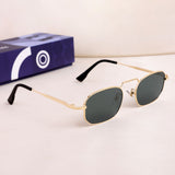Gold-framed sunglasses with a box on a light background