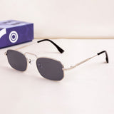 Sunglasses with a silver frame and dark lenses on a white background