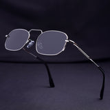Sunglasses with thin metal frame on a dark background