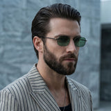 Man wearing sunglasses and a striped suit against a blurred background
