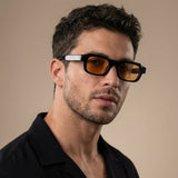 Man wearing sunglasses with a neutral background