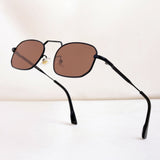 Sunglasses with brown lenses and black frames on a white background