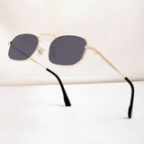 Sunglasses with gold frame and black lenses on a white background