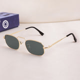 Gold-framed sunglasses with dark lenses on a light surface