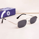 Sunglasses with dark lenses and thin metal frame on a light background