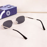 Sunglasses with black lenses and silver frames on a white surface with a blue box in the background.